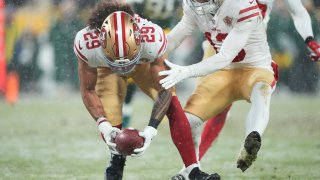 GREEN BAY, WISCONSIN – JANUARY 22: Safety Talanoa Hufanga #29 of the San Francisco 49ers recovers a blocked punt and runs the ball in for a touchdown during the 4th quarter of the NFC Divisional Playoff game against the Green Bay Packers at Lambeau Field on January 22, 2022 in Green Bay, Wisconsin. (Photo by Patrick McDermott/Getty Images)