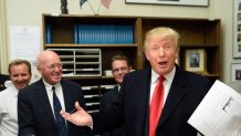 Republican presidential candidate Donald Trump files for the New Hampshire state ballot as New Hampshire Secretary of State William Gardner (L) looks on, November 4, 2015 in Concord, New Hampshire. AFP PHOTO/DON EMMERT (Photo credit should read DON EMMERT/AFP via Getty Images)