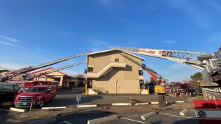 fire ladders battle the flames at Ramada Boston