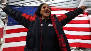 Elana Meyers Taylor celebrates with an American flag