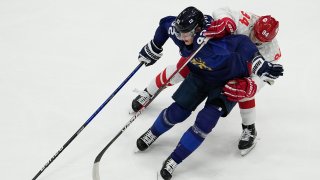 Russian Olympic Committee's Kirill Semyonov (94) pressures Finland's Harri Pesonen (82) during the men's gold medal hockey game at the 2022 Winter Olympics, Feb. 20, 2022, in Beijing, China.