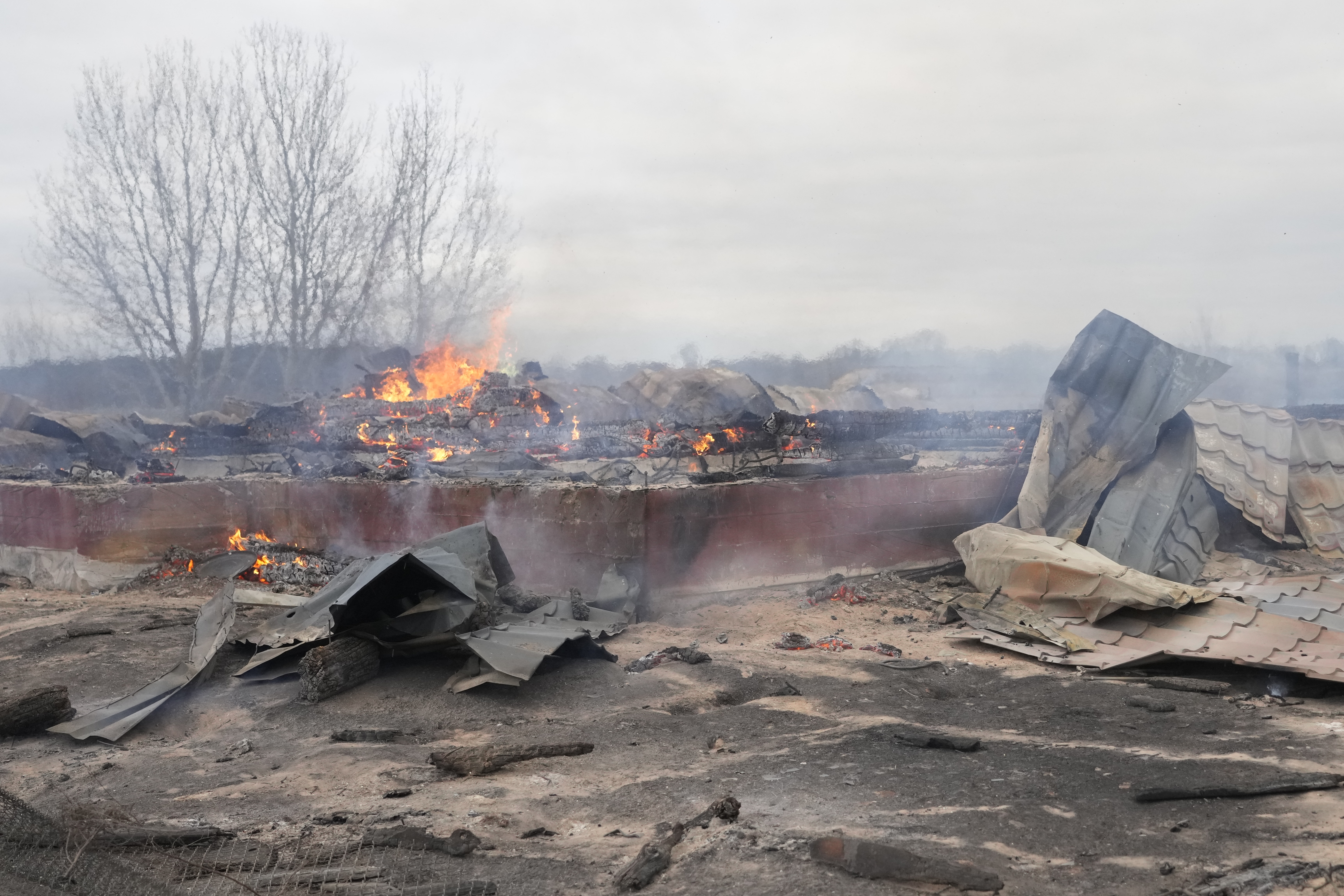 Smoke and flame rise from the debris of a private house in the aftermath of Russian shelling outside Kyiv, Ukraine, Thursday, Feb. 24, 2022.