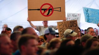 A man displays an anti gun violence sign