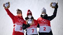 (From L to R) Silver medallist China's Eileen Gu, gold medallist Switzerland's Mathilde Gremaud and bronze medallist Estonia's Kelly Sildaru pose on the podium during the venue ceremony after the Freestyle Skiing Women's Freeski Slopestyle final run during the Beijing 2022 Winter Olympic Games at the Genting Snow Park H & S Stadium in Zhangjiakou, China on Feb. 15, 2022.