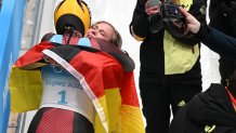 Team Germany's Natalie Geisenberger, gold medallist, and Anna Berreiter, silver medallist, celebrate during the Women's Singles Luge