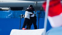 Su Yiming of Team China hugs his coach Yasuhiro Sato during the Men's Snowboard Big Air final on day 11 of the Winter Olympics at Big Air Shougang on Feb. 15, 2022, in Beijing, China.