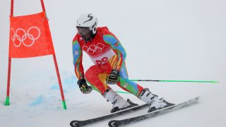 Shannon Abeda of Eritrea passes a gate during the first run of the men's giant slalom at the 2022 Winter Olympics, Feb. 13, 2022, in the Yanqing district of Beijing.