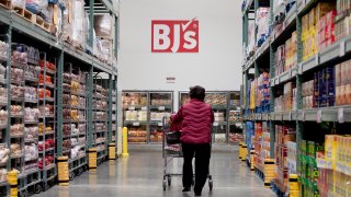 A customer walks through an aisle of a BJ’s Wholesale Club Inc. store in Falls Church, Virginia, U.S.