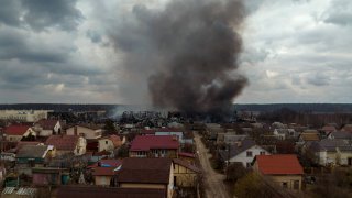A factory and a store burn after being bombarded in Irpin, on the outskirts of Kyiv, Ukraine, Sunday, March 6, 2022.