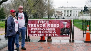 Joey and Paula Reed, parents of U.S. Marine Corps veteran and Russian prisoner Trevor Reed, stand in Lafayette Park near the White House, Wednesday, March 30, 2022, in Washington.