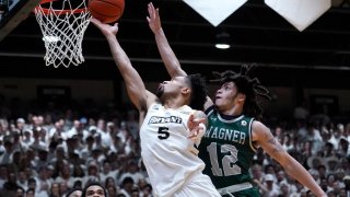 Bryant guard Charles Pride (5) drives to the basket against Wagner guard Zaire Williams (12) during the first half of the Northeast Conference