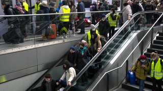 Refugees from the Ukraine are guided by volunteers as they arrive at the main train station in Berlin, Germany, Tuesday, March 15, 2022. The Ukraine war has turned the basement of Berlin’s glass-and-steel main train station into a sprawling refugee town where a small army of volunteers in yellow and orange vests offer everything from shampoo to cell phone chargers to exhausted refugees.