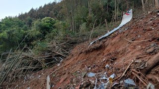 In this photo taken by mobile phone released by Xinhua News Agency, a piece of wreckage of the China Eastern's flight MU5735 are seen after it crashed on the mountain in Tengxian County, south China's Guangxi Zhuang Autonomous Region on Monday, March 21, 2022. A China Eastern Boeing 737-800 with 132 people on board crashed in a remote mountainous area of southern China on Monday, officials said, setting off a forest fire visible from space in the country's worst air disaster in nearly a decade.