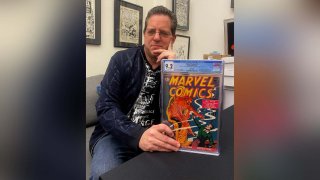 Stephen Fishler, co-owner and CEO of ComicConnect.com, poses for a photo holding up a copy of Marvel Comics #1, Friday, March 18, 2022, in New York. The prized copy of the first-ever Marvel comic book has fetched over $2.4 million in an online auction.