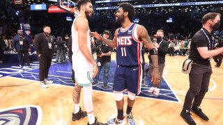 Jayson Tatum #0 of the Boston Celtics talks to Kyrie Irving #11 of the Brooklyn Nets after Round 1 Game 4 of the 2022 NBA Playoffs on April 25, 2022 at Barclays Center in Brooklyn, New York.