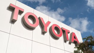 Close-up of sign with logo on building facade at the San Francisco regional headquarters of automotive company Toyota
