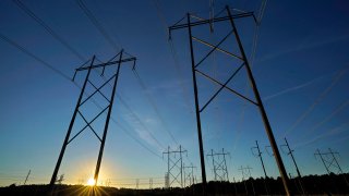 Central Maine Power utility lines as seen in Pownal, Maine, Oct. 6, 2021. Maine's highest court is scheduled to hear arguments May 10, 2022 on an attempt to overturn a referendum that ended a $1 billion power line to tap into Canadian hydropower.