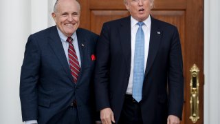 President-elect Donald Trump, right, and former New York Mayor Rudy Giuliani pose for photographs as Giuliani arrives at the Trump National Golf Club Bedminster clubhouse, Sunday, Nov. 20, 2016, in Bedminster, N.J..