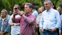 Brian Kemp, R-Ga., takes a photo as Georgia Secretary of State Brad Raffensperger