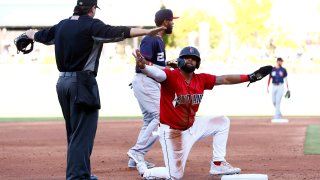 Indianapolis Indians outfielder Canaan Smith-Njigba (28) signals he is safe along with the home plate umpire on the play at third during a MiLB baseball game between the Louisville Bats and the Indianapolis Indians on May 07, 2022 at Victory Field in Indianapolis, IN.