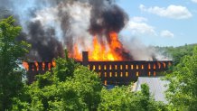 An abandoned mill in Orange, Massachusetts, goes up in flames on Saturday, June 4, 2022.