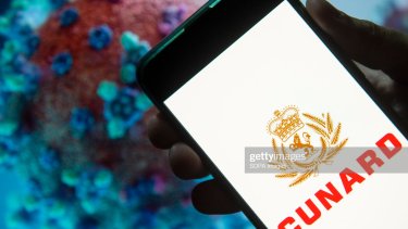 CHINA - 2020/03/25: In this photo illustration the cruise line company Cunard logo seen displayed on a smartphone with a computer model of the COVID-19 coronavirus on the background. (Photo by Budrul Chukrut/SOPA Images/LightRocket via Getty Images)