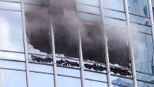 Smoke pours from blown-out windows in a Boston high-rise Friday, June 24, 2022.