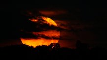 The moon rising over Lake Quannapowitt in Wakefield, Massachusetts.