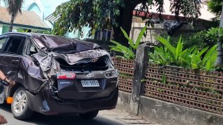 A damaged car is seen along a road