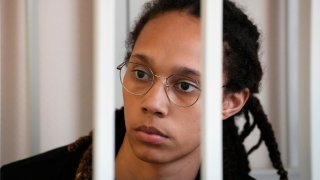 FILE - WNBA star and two-time Olympic gold medalist Brittney Griner sits in a cage