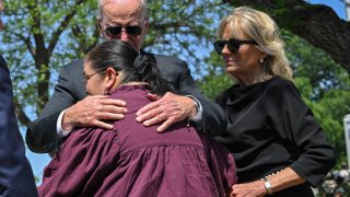 File - President Joe Biden embraces Principal Mandy Gutierrez as he and first lady Jill Biden visit Uvalde, Texas on May 29, 2022.