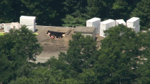 The hole left in an apartment building's roof in a partial collapse on Friday, July 15, 2022.