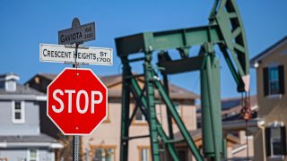 Oil well and pump jacks near housing developments in the City of Signal Hill in Los Angeles County, California.
