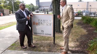 Fred Hodges, left, and Da'ee McKnight talk outside where they work at Family ReEntry a reentry support group