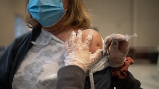 A resident receives a Covid-19 booster shot at a vaccine clinic inside Trinity Evangelic Lutheran Church in Lansdale, Pennsylvania, U.S, on Tuesday, Apr. 5, 2022.