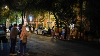 People gather outside after an earthquake was felt in Mexico City