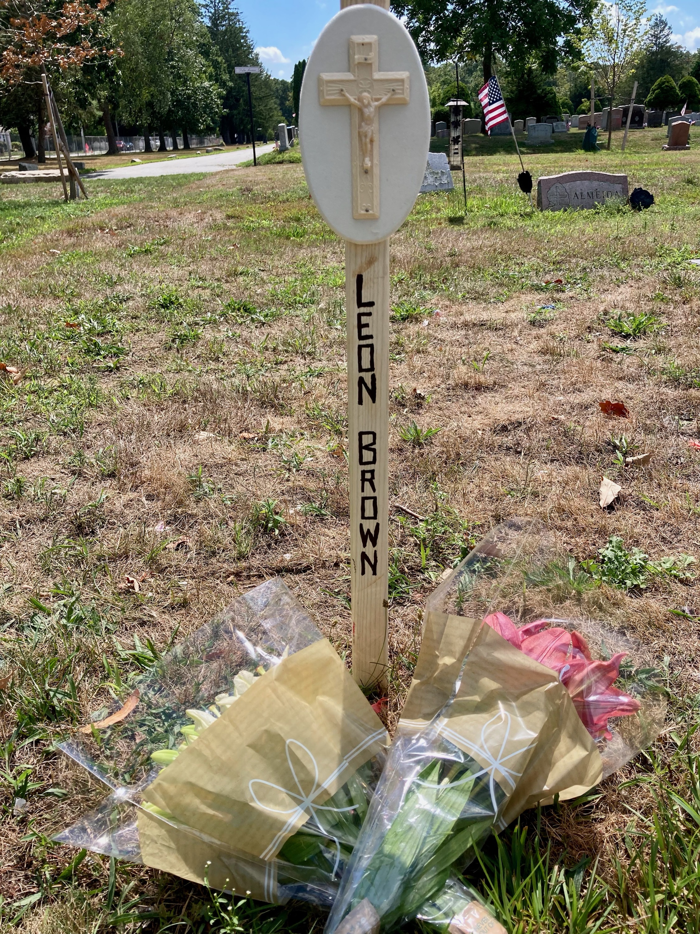Members of the Bristol County District Attorney's Office placed flowers and a temporary marker at Leon Brown's gravesite.