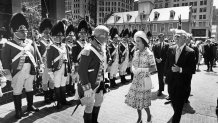 Mayor Kevin White escorts Queen Elizabeth II through Washington Mall in Boston on the way to City Hall ceremonies as Colonel Vincent J. R. Kehoe, left, and his 10th Regiment of Foot, Chelmsford, guard the way on July 11, 1976.