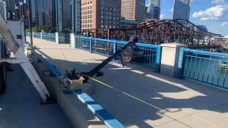 A pole fell on Moakley Bridge in Boston Tuesday, leaving a woman hurt