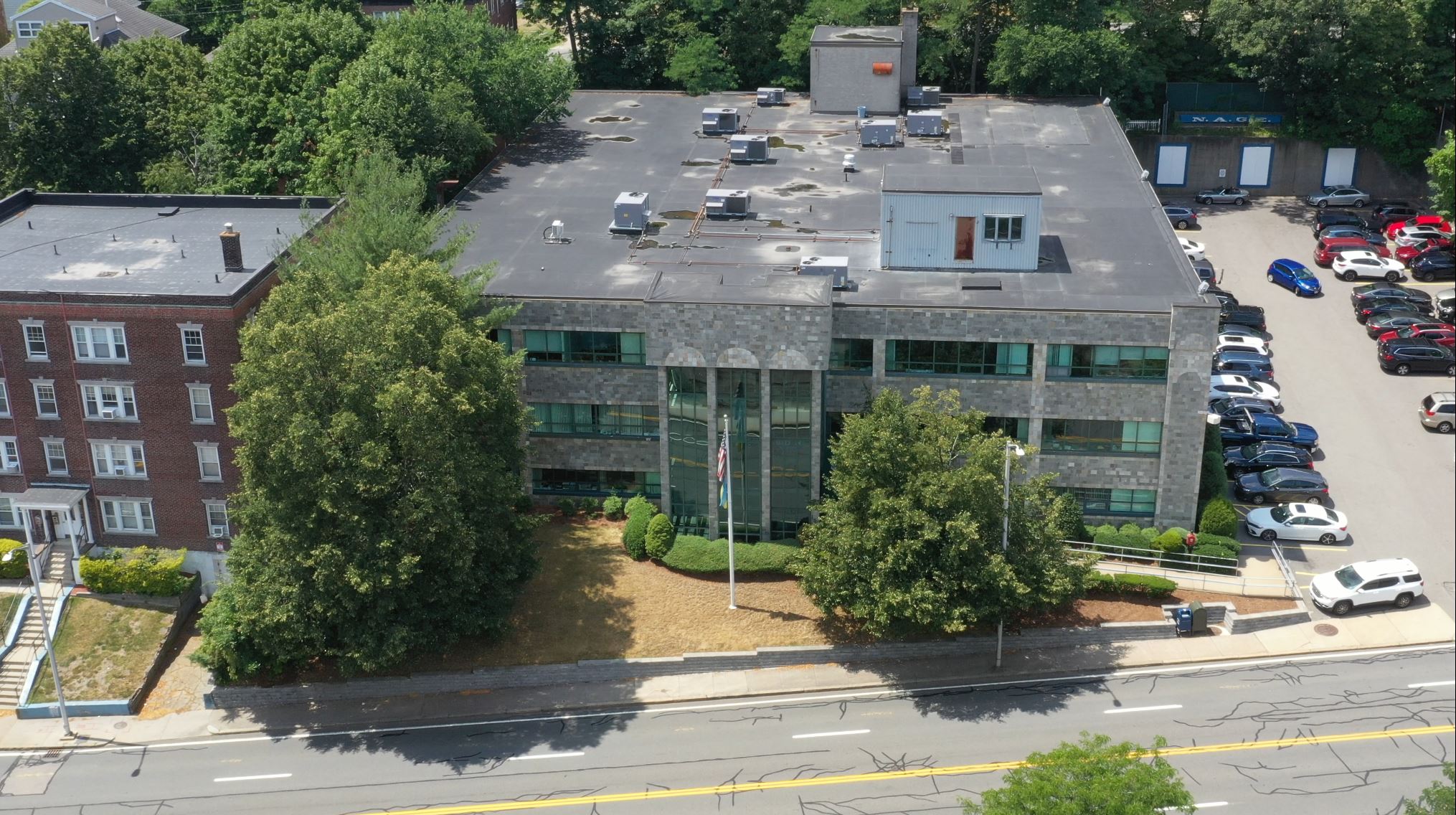 an aerial view of an office building. with two trees in front of it