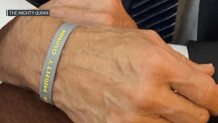 President Joe Biden wearing a "Mighty Quinn" bracelet on Air Force One while flying from Boston to Washington, D.C., on Monday, Sept. 12, 2022.