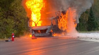 A FedEx truck is engulfed with flames alongside Interstate 91 in Vermont