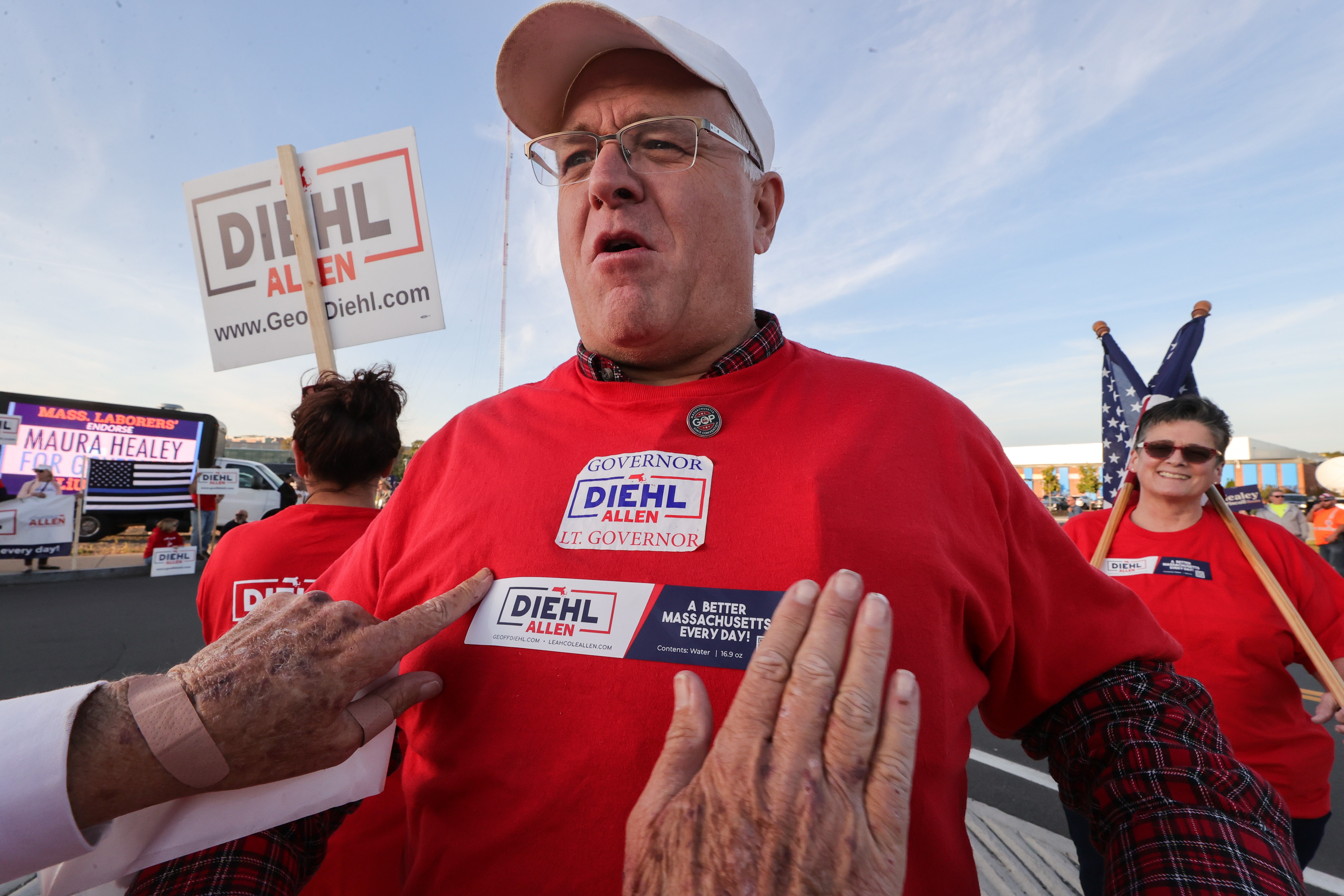 Supporters of Democrat Maura Healey and Republican Geoff Diehl outside the Boston Media Center before the candidates’ first debate in the Massachusetts governor’s race.