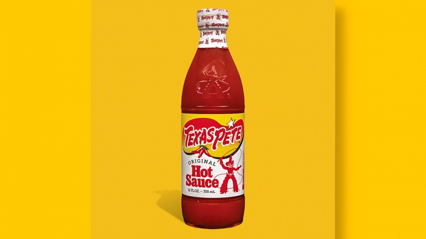 Bottle of Texas Pete hot sauce in front of yellow background.