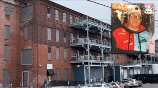 a background of a large brick building with an inset imaage of a woman wearing a baseball cap and sweatshirt