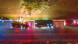 First responders on scene after a minivan veered off Interstate 495 and crashed in Wareham, Massachusetts, late Monday, Oct. 17, 2022.