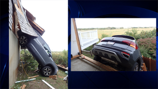 Car crashes through garage