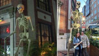 The giant skeleton outside Wusong Road, a Cambridge tiki bar and restaurant near Harvard University, after one of its arms was stolen (at left) and after a couple from Worcester brought their own giant skeleton arm to replace it (at right)