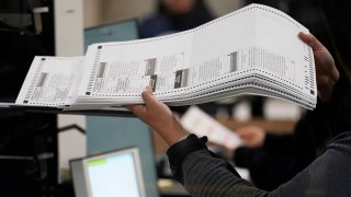 An election worker processes ballots at the Clark County Election Department