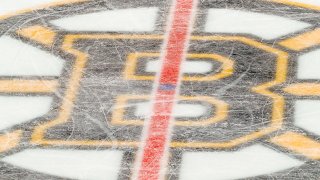 This Dec. 5, 2019, file photo shows the Boston Bruins logo at center ice in TD Garden.